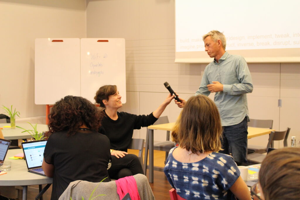 Moderator handing over the microphone to Sara Hendren at a 2018 event at KTH, Stockholm. Photo credit: Francesca Albrezzi.